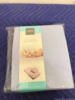 Front of packaged Kushies light blue crib sheet