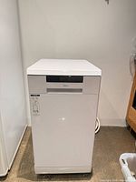 Front view of white slim Midea dishwasher