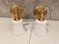 Pair of brass sconces upright showing front view