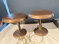 Front view of both metal table lamps showing overall design and finish