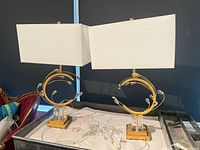 Pair of gold table lamps with white rectangular shades on table