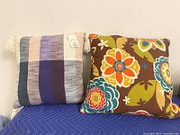 Front view of pillows showing floral print and woven vertical stripes