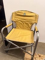 Front view of Woods yellow canvas folding chair on aluminum frame