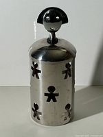Full view of stainless steel garlic jar with lid and figure finial