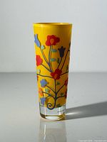 full view of yellow floral glass vase showing design and signature