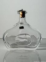 overall view of clear glass Erik Höglund Boda decanter with bull relief and original stopper