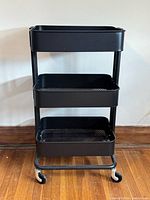 Full view of the three-tier black metal rolling cart