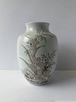 Front view of white porcelain vase with floral motif