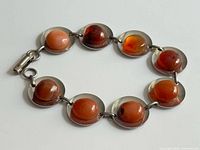 Full view of bracelet showing eight carnelian stones and clasp