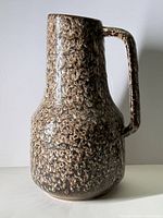 Front view showing jug shape, handle, glaze pattern