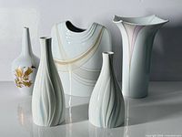 Group shot of five modern porcelain vases on white backdrop