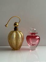 Both perfume bottles side by side for scale and comparison