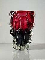 Front view showing red to blue gradient and sculpted clear base