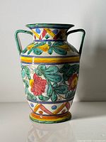 Full view of vase front showing floral design and handles
