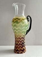Front view of Kosta Boda Safari pitcher showing pattern, spout and handle