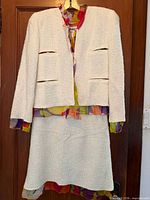 Front view of Chanel ivory tweed jacket and skirt showing lining