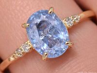 Top view showing oval tanzanite and side diamonds in gold setting