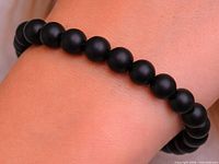 bracelet worn on wrist, showing matte onyx beads