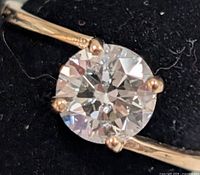 Close-up of round brilliant lab diamond in prong setting