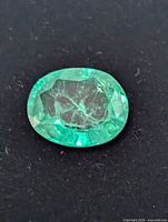 Close view of the loose oval emerald