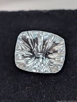 Top view of blue topaz showing fantasy starburst facets