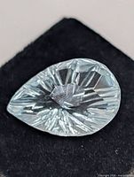 Close-up of light blue pear fantasy cut gemstone