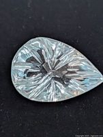 Pear-shaped fantasy-cut blue topaz close-up front view