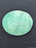 front view of oval emerald showing color and inclusions