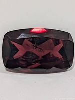 Front view of faceted rectangular cushion garnet
