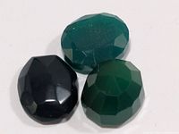 Three faceted agate stones grouped on white background