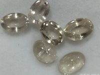 Six oval zultanite stones on felt