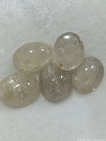 Five oval cabochon gemstones close-up
