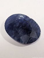 Top view of oval blue sapphire showing facets and inclusions