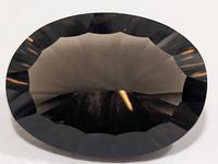 Front view of faceted smokey quartz showing oval shape and pavilion facets