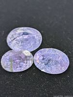 Close-up of three tanzanite gemstones showing color and cut