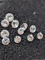 Close-up of loose round white sapphires on black background