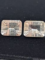 Close-up of both rectangular white topaz gemstones