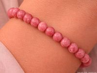 Bracelet worn on wrist, showing bead color and size