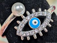 Front view showing pearl and evil eye motif with CZ halo
