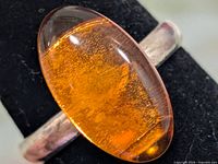 front view showing amber cabochon and silver band