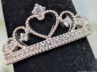 front view of silver crown ring showing heart motif and pavé CZ stones