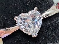 Heart-shaped clear CZ stone set on silver band close-up