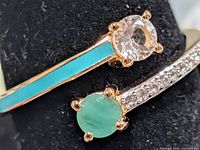 Close-up showing emerald, topaz, turquoise inlay and pavé detail