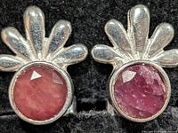 Front view of both earrings showing ruby stones and silver fan tops