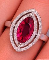 Ring on finger showing overall design and stone color