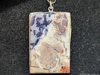 Front view of rectangular jasper pendant in silver setting