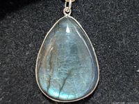 Front view of pendant showing labradorite flash and silver bezel
