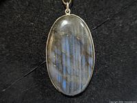 Front view of oval labradorite pendant in silver bezel