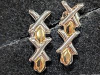 Front view of earrings showing design and metal tones