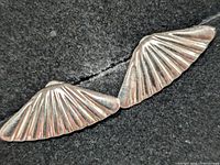 Front view of both earrings showing fan design